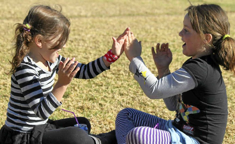 Ella Talbot and Nadine Sampson play clapping games in the sunshine at the weekend. Ella Talbot and Nadine Sampson play clapping games in the sunshine at the weekend.